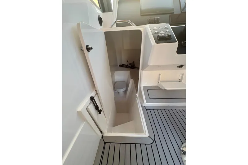  Yacht Photos Pics Interior of 2026 Hammer Yachts 35HH, featuring compact marine toilet and control panel.