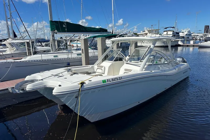 World Cat 296 Dc Yacht Photos Pics 2020 World Cat 296 DC boat docked in a marina under a clear blue sky.