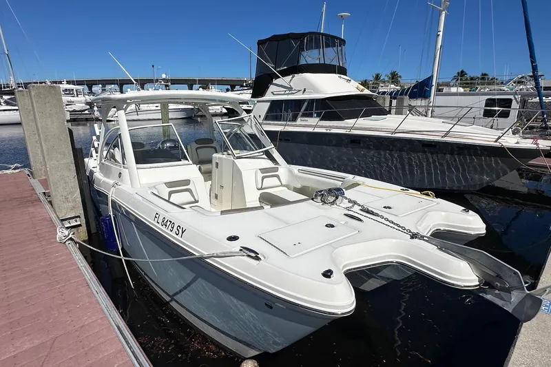 World Cat 296 Dc Yacht Photos Pics 2020 World Cat 296 DC boat docked at marina under clear blue sky.