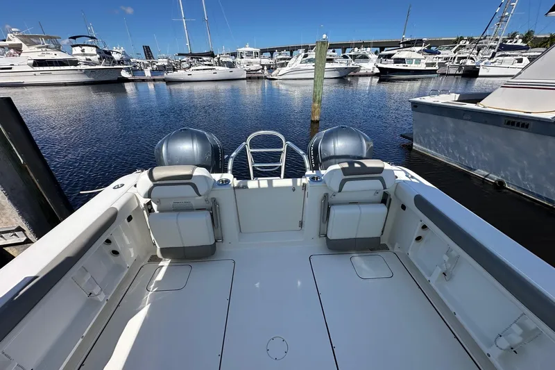 World Cat 296 Dc Yacht Photos Pics 2020 World Cat 296 DC boat docked in a marina with multiple yachts.