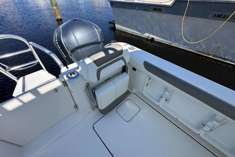World Cat 296 Dc Yacht Photos Pics 2020 World Cat 296 DC boat interior with Yamaha engine, docked on calm water.
