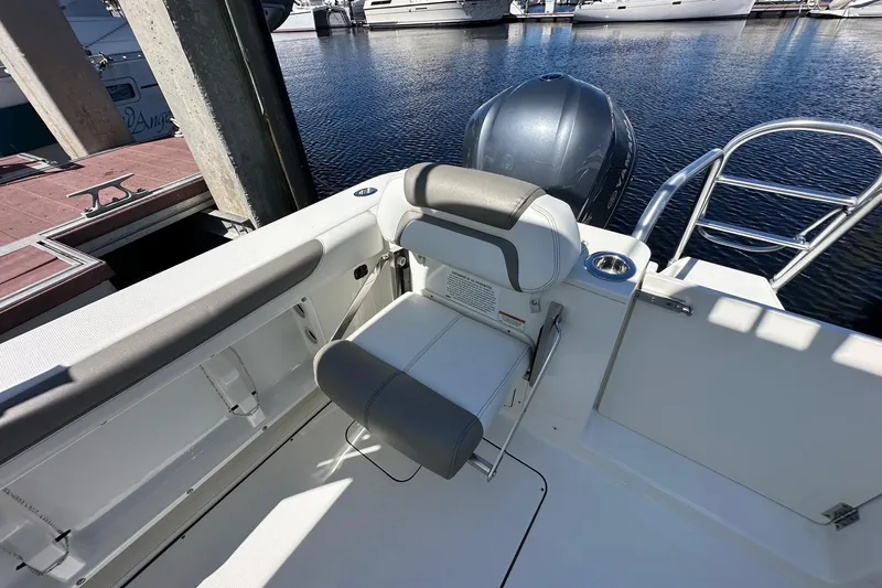 World Cat 296 Dc Yacht Photos Pics 2020 World Cat 296 DC boat interior with seating and outboard motor at marina.