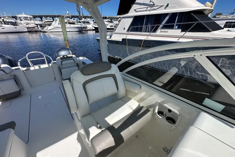 World Cat 296 Dc Yacht Photos Pics 2020 World Cat 296 DC boat interior at marina, featuring comfortable seating and sleek design.