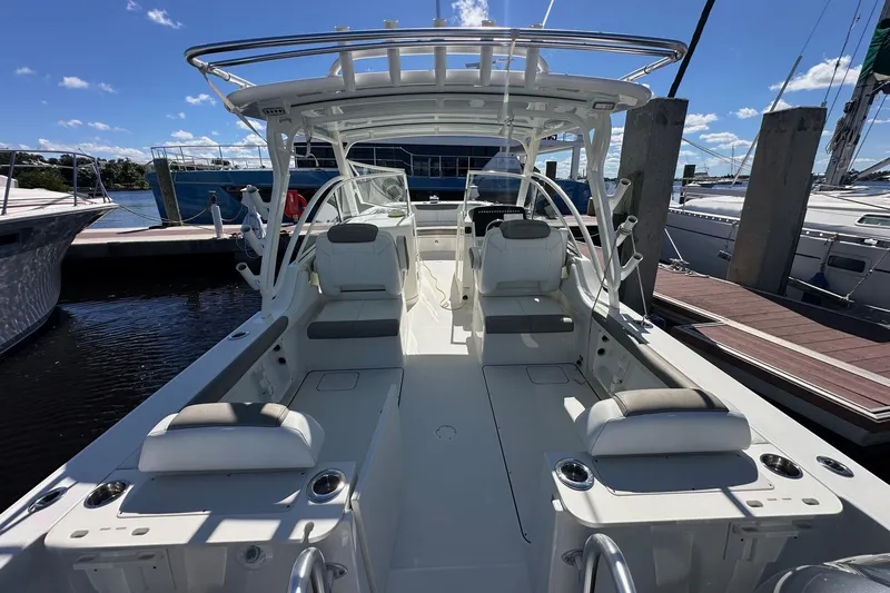 World Cat 296 Dc Yacht Photos Pics 2020 World Cat 296 DC boat interior at marina, showcasing seating and helm.