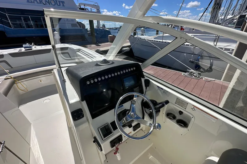 World Cat 296 Dc Yacht Photos Pics 2020 World Cat 296 DC boat cockpit with steering wheel and control panel.