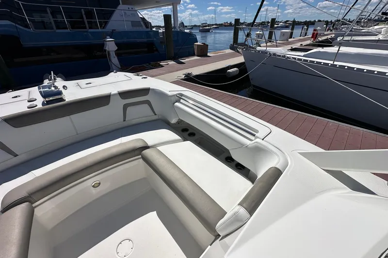 World Cat 296 Dc Yacht Photos Pics 2020 World Cat 296 DC boat interior at marina, featuring comfortable seating and docked yachts.
