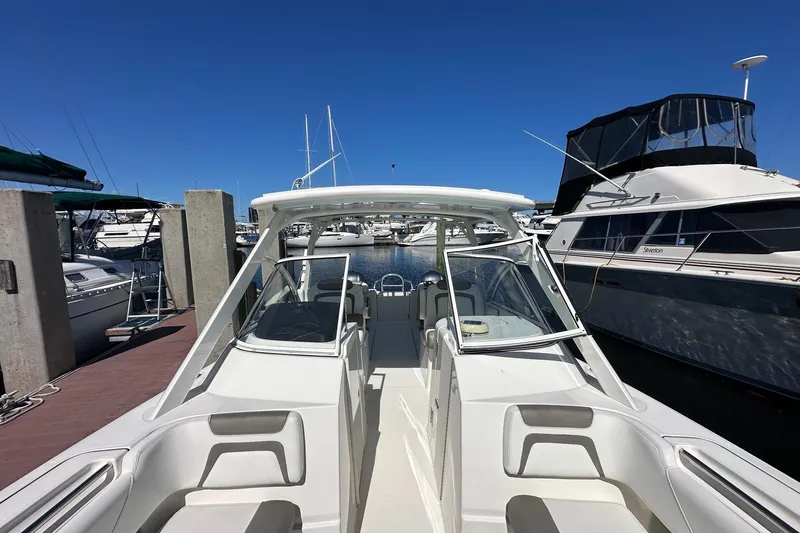 World Cat 296 Dc Yacht Photos Pics 2020 World Cat 296 DC boat docked at marina under clear blue sky.