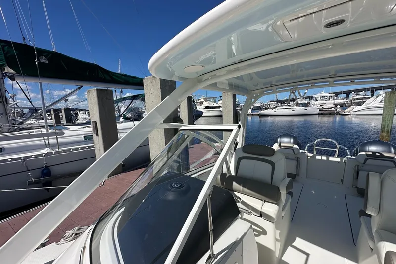 World Cat 296 Dc Yacht Photos Pics 2020 World Cat 296 DC boat docked at marina, showcasing spacious seating and sleek design.