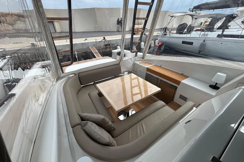  Yacht Photos Pics Luxurious interior of 2021 Bluegame BG42 yacht with elegant seating and wooden table.