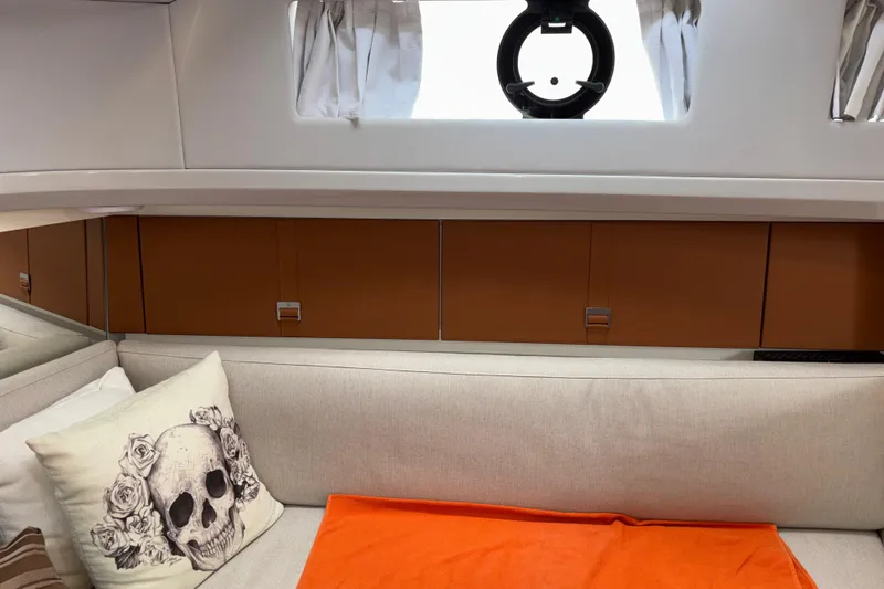  Yacht Photos Pics Interior of 2021 Bluegame BG42 yacht with skull pillow and orange blanket.