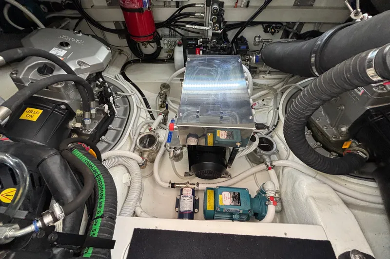  Yacht Photos Pics Engine room of 2021 Bluegame BG42 yacht, showcasing complex machinery and wiring.