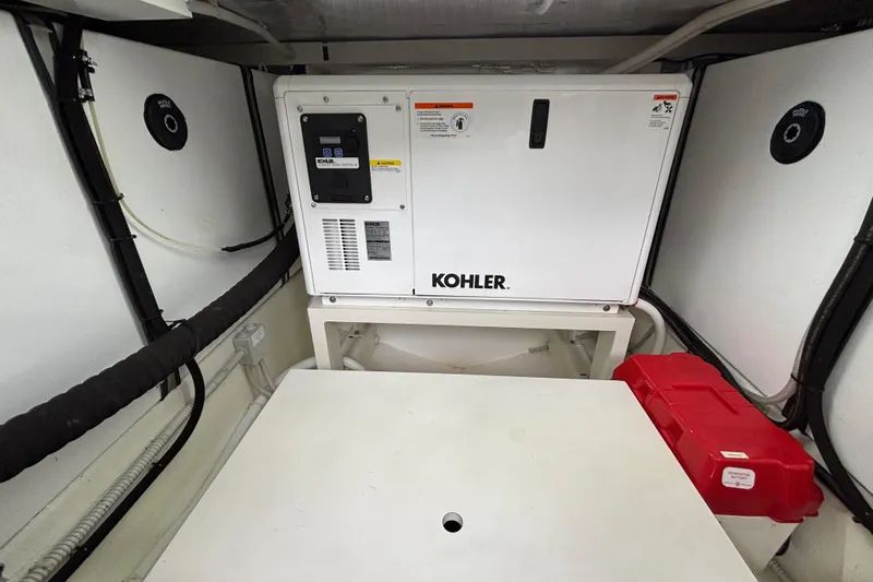  Yacht Photos Pics Engine room of 2021 Bluegame BG42 with Kohler generator and red storage box.