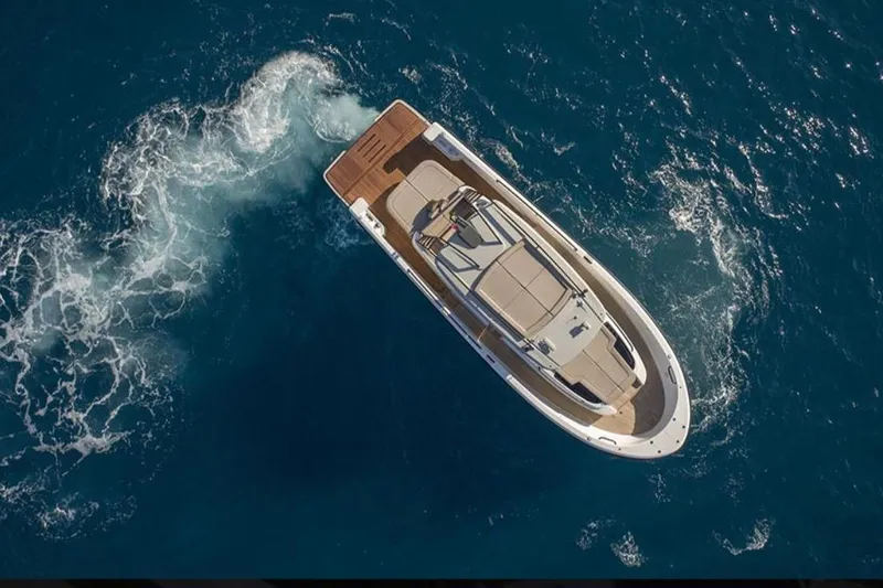  Yacht Photos Pics Aerial view of 2021 Bluegame BG42 yacht cruising in open blue waters.