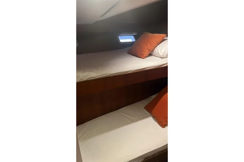 New Beginning Yacht Photos Pics Bunk beds in 1990 Cheoy Lee 75 yacht cabin with orange pillows.