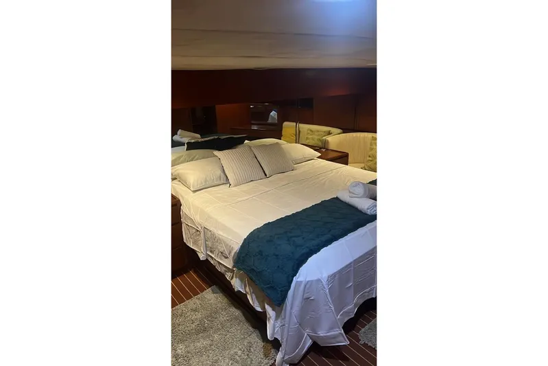 New Beginning Yacht Photos Pics Luxurious bedroom interior of 1990 Cheoy Lee 75 yacht with elegant bedding.