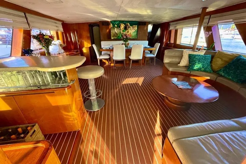New Beginning Yacht Photos Pics Luxurious interior of a 1990 Cheoy Lee 75 yacht with elegant seating and dining area.