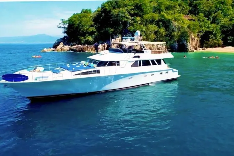New Beginning Yacht Photos Pics Luxurious 1990 Cheoy Lee 75 yacht anchored near scenic tropical coastline.
