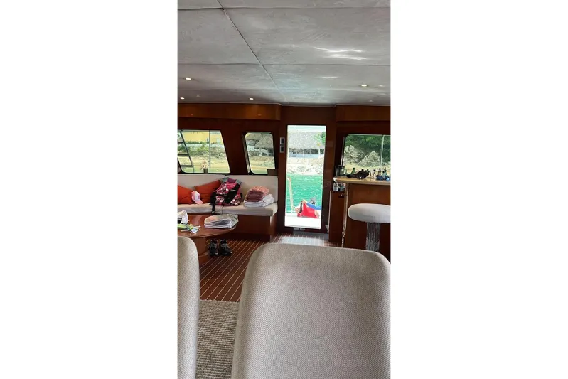 New Beginning Yacht Photos Pics Interior of 1990 Cheoy Lee 75 yacht with cozy seating and scenic view.