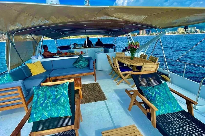 New Beginning Yacht Photos Pics Luxurious 1990 Cheoy Lee 75 yacht deck with seating, dining area, and ocean view.