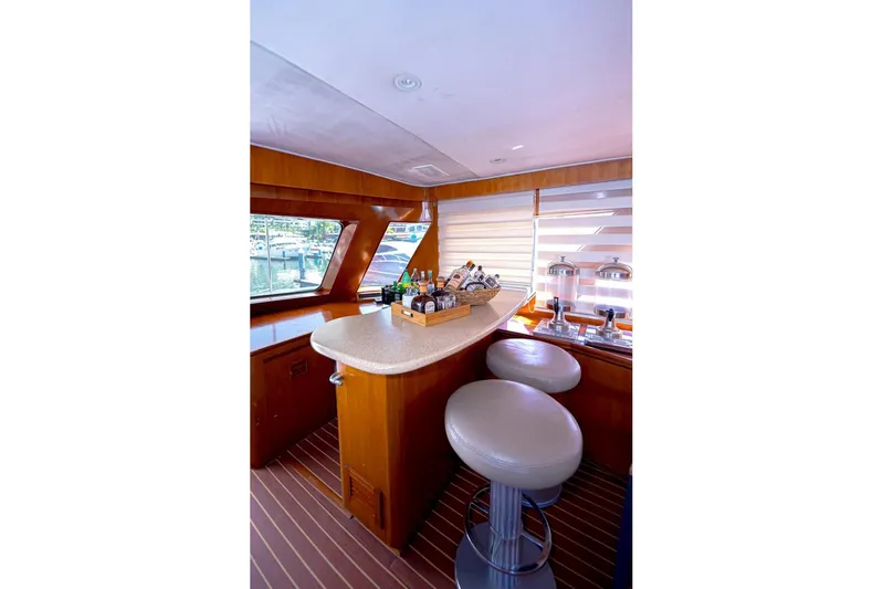 New Beginning Yacht Photos Pics Luxurious interior of 1990 Cheoy Lee 75 yacht with elegant bar and seating area.