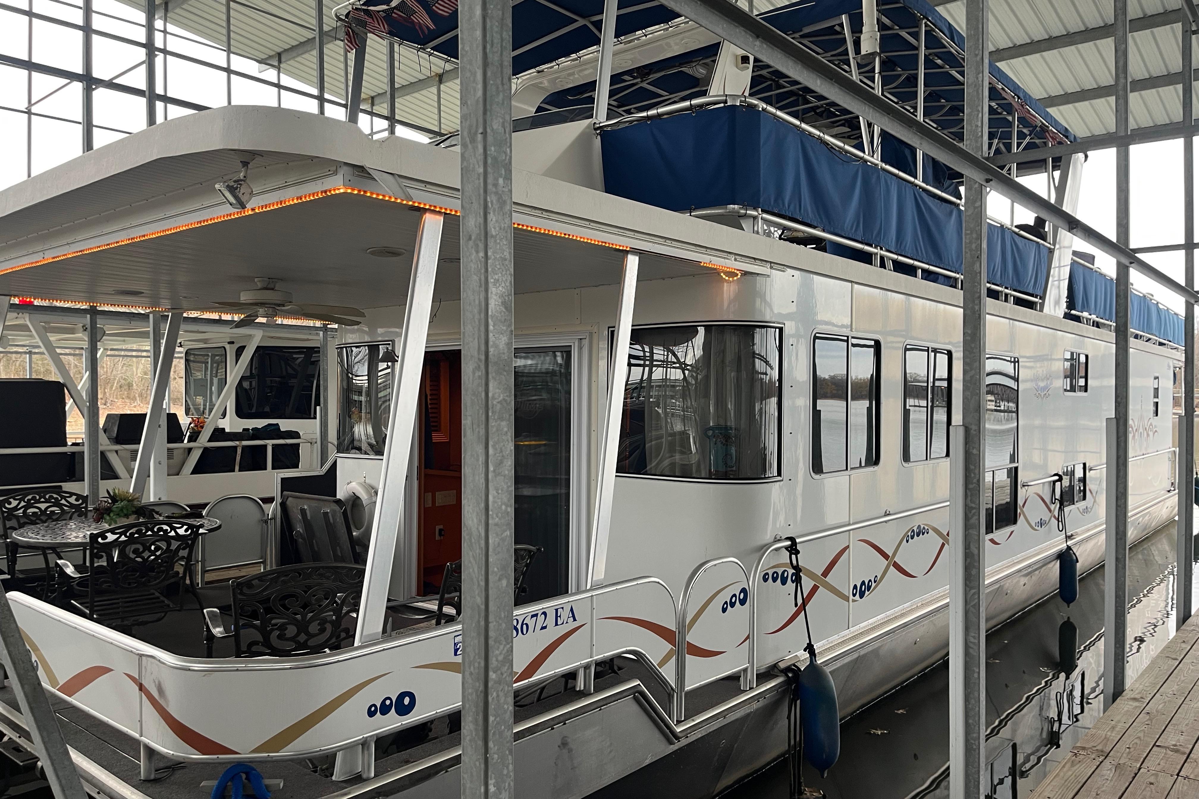 2010 Funtime 68x16 houseboat docked in a covered marina.