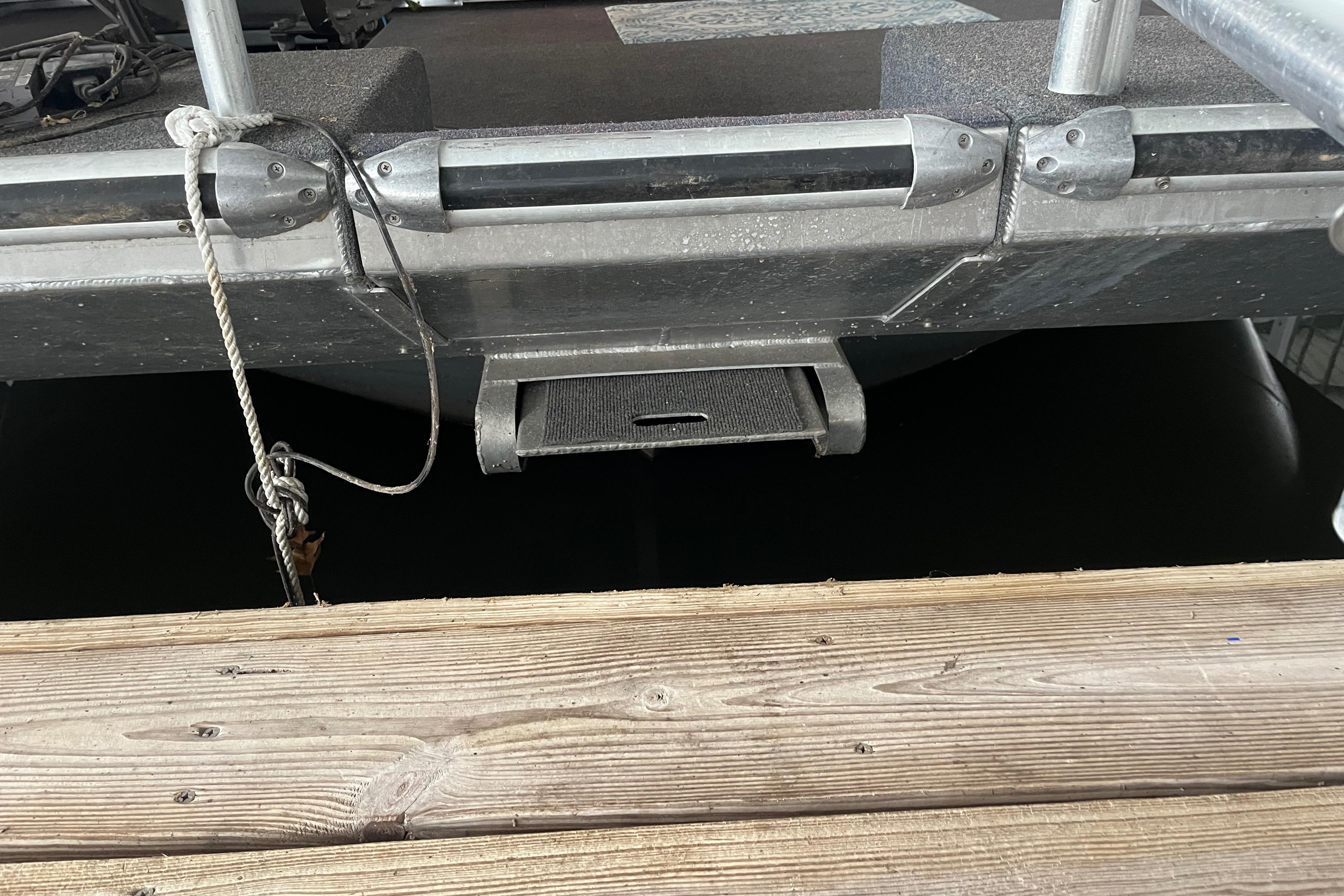 Funtime 68x16 boat docked, showing metal structure and wooden pier, 2010 model.