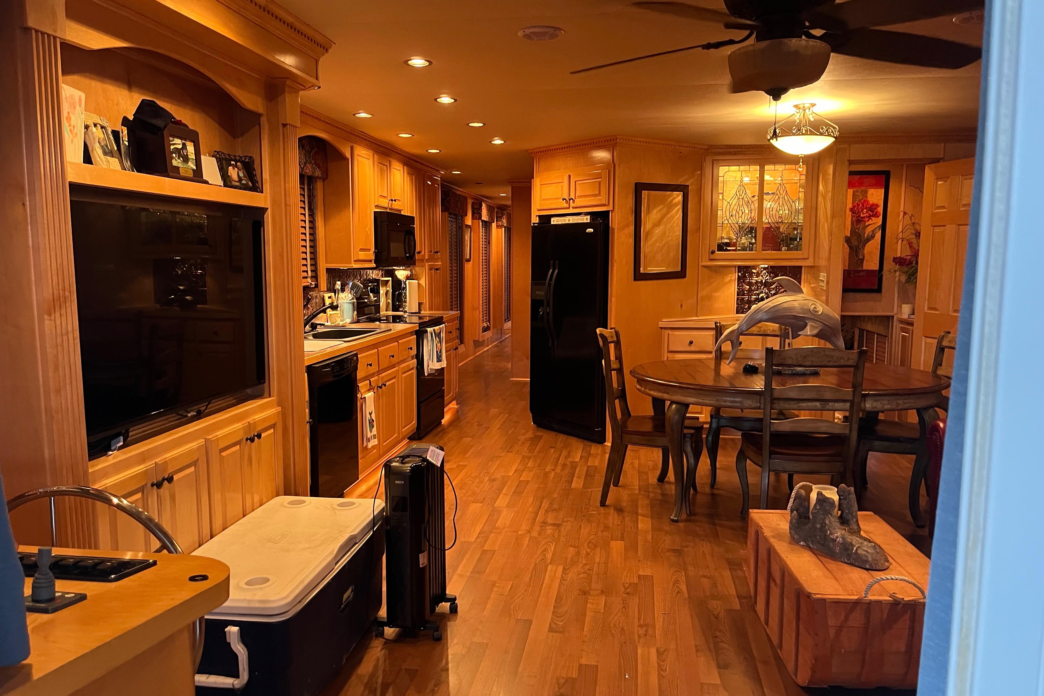 Luxurious 2010 Funtime 68x16 houseboat interior with wooden decor and modern amenities.