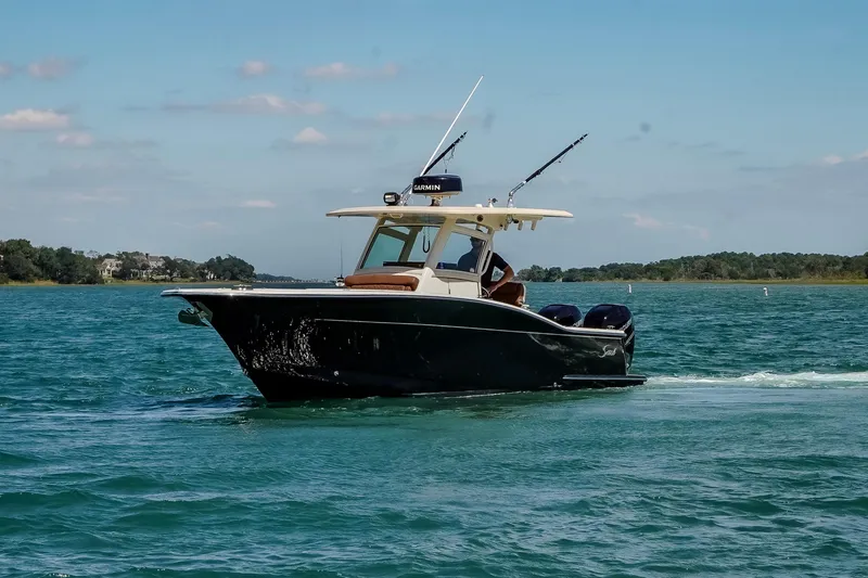  Yacht Photos Pics 2017 Scout 300 LXF boat cruising on clear blue water under a sunny sky.