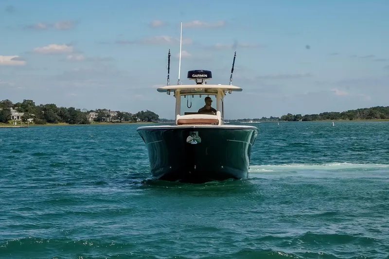  Yacht Photos Pics 2017 Scout 300 LXF boat cruising on a sunny day in calm waters.