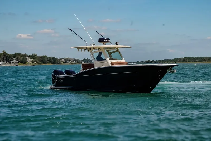  Yacht Photos Pics 2017 Scout 300 LXF boat cruising on clear blue water under a sunny sky.
