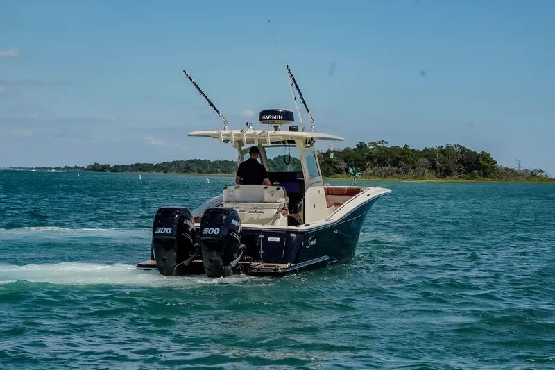  Yacht Photos Pics 2017 Scout 300 LXF boat cruising on blue water with dual engines.