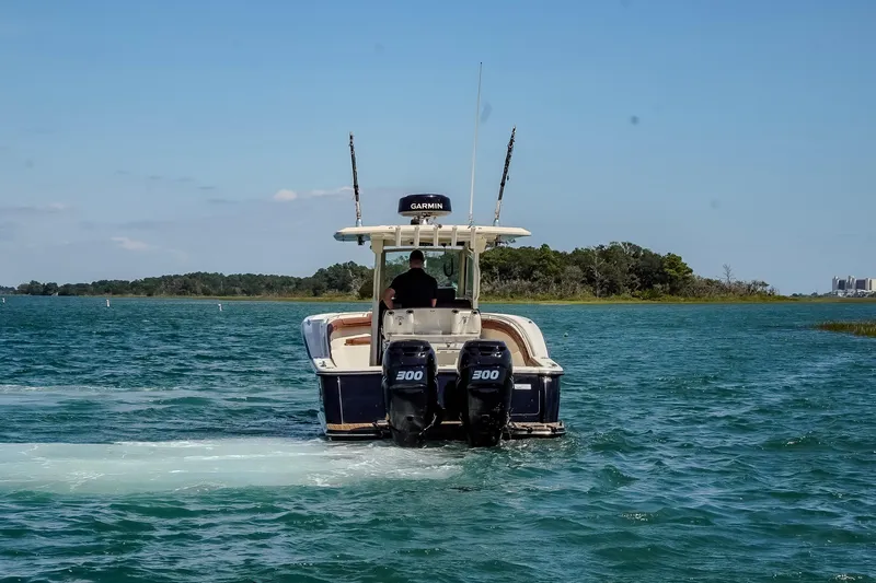  Yacht Photos Pics 2017 Scout 300 LXF boat cruising on a clear blue lake.