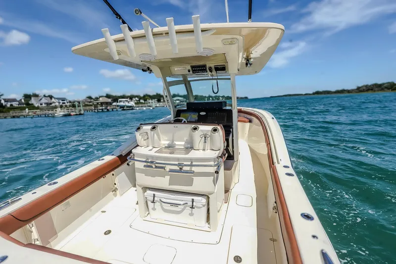  Yacht Photos Pics 2017 Scout 300 LXF boat cruising on clear blue water under a sunny sky.