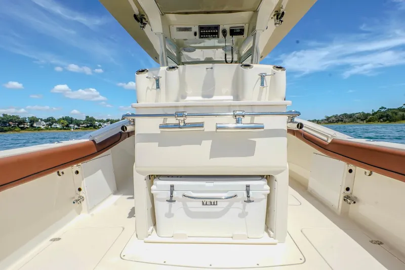  Yacht Photos Pics 2017 Scout 300 LXF boat interior with Yeti cooler, ocean view, and clear blue sky.