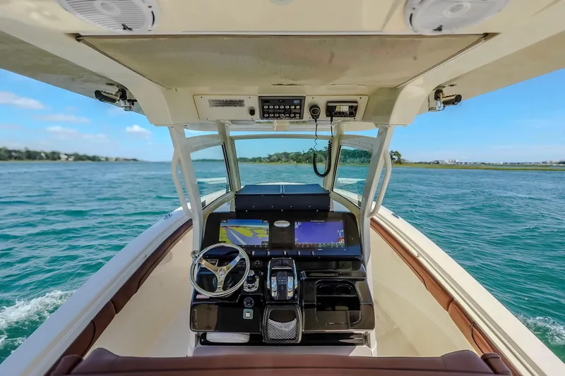  Yacht Photos Pics 2017 Scout 300 LXF boat dashboard with navigation screens on open water.