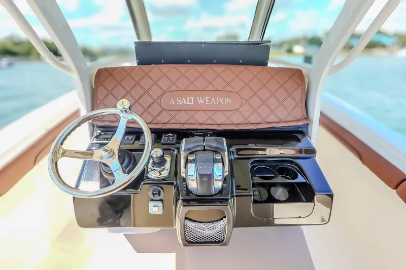  Yacht Photos Pics 2017 Scout 300 LXF boat dashboard with steering wheel and controls, labeled "A Salt Weapon."