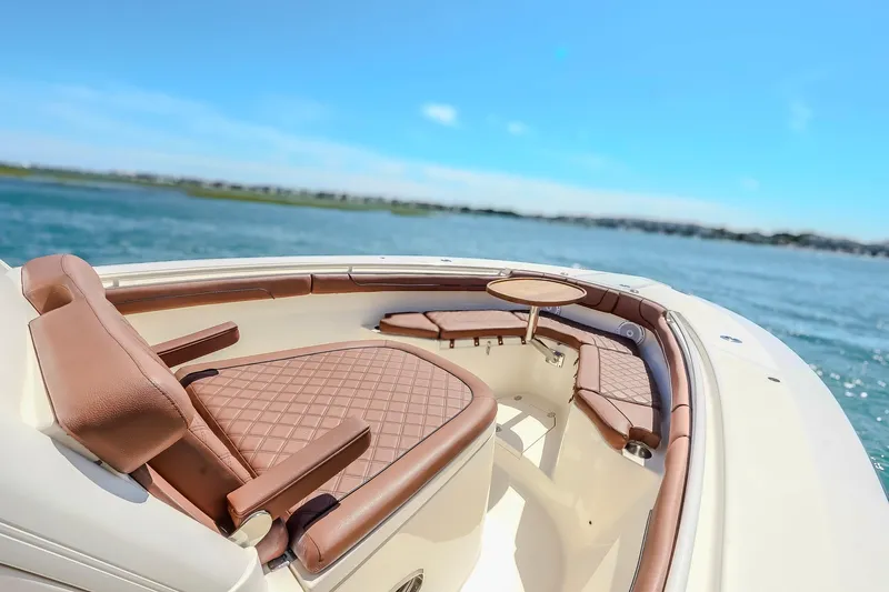  Yacht Photos Pics 2017 Scout 300 LXF boat interior with luxurious seating and table on open water.