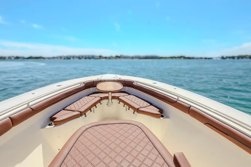  Yacht Photos Pics 2017 Scout 300 LXF boat interior with brown seating, overlooking calm blue waters.