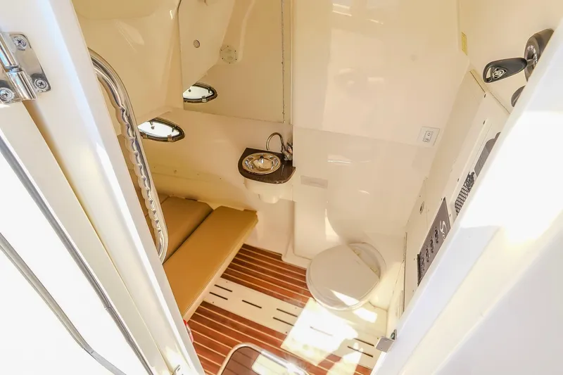  Yacht Photos Pics 2017 Scout 300 LXF cabin interior with seating, sink, and toilet.