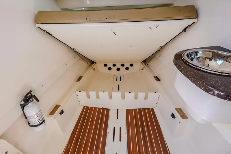  Yacht Photos Pics 2017 Scout 300 LXF cabin interior with wooden flooring and compact sink.