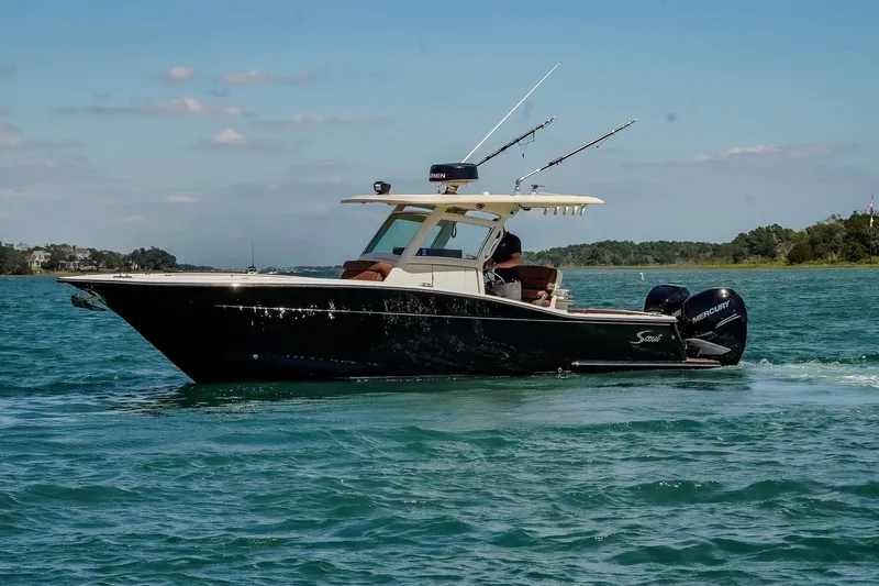  Yacht Photos Pics 2017 Scout 300 LXF boat cruising on a sunny day with fishing rods.