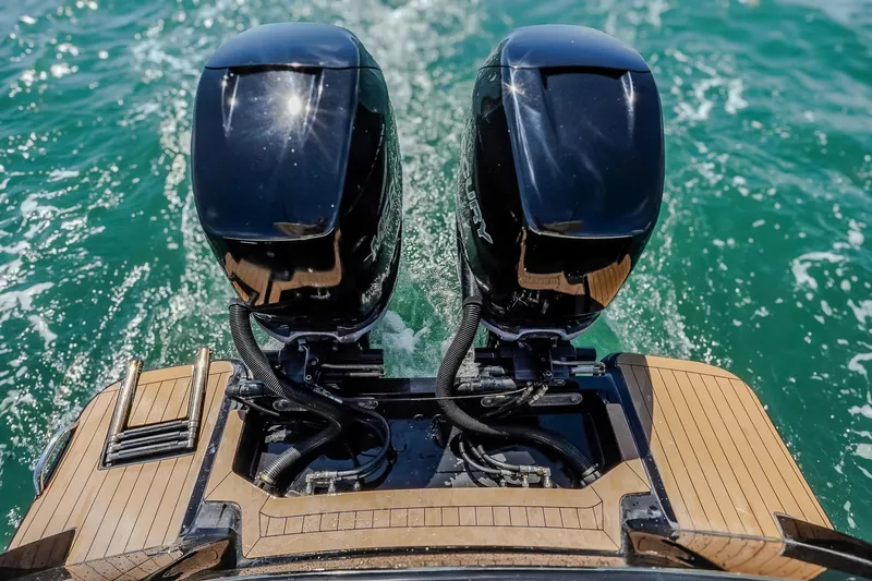  Yacht Photos Pics 2017 Scout 300 LXF boat with dual outboard motors on turquoise water.