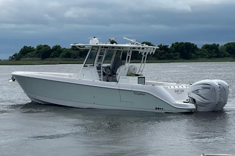 Let's Dance Yacht Photos Pics Edgewater 340CC 2020 boat with twin Yamaha engines on a calm waterway.
