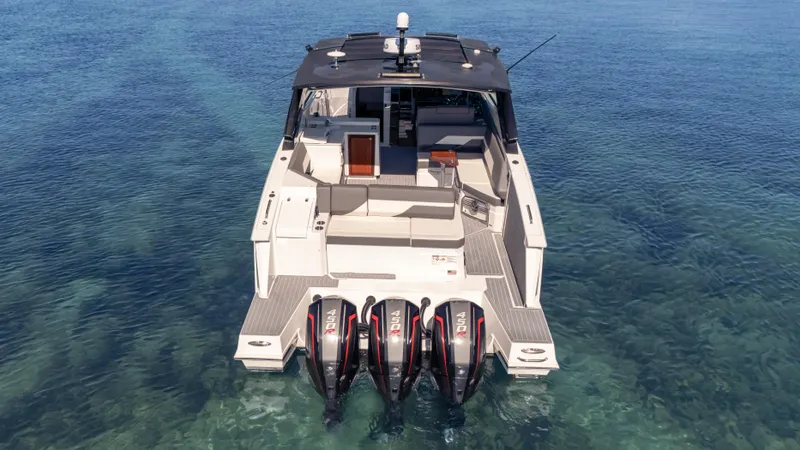  Yacht Photos Pics 2021 Cruisers Yachts 38 GLS OB 450R on clear water, rear view with triple engines.