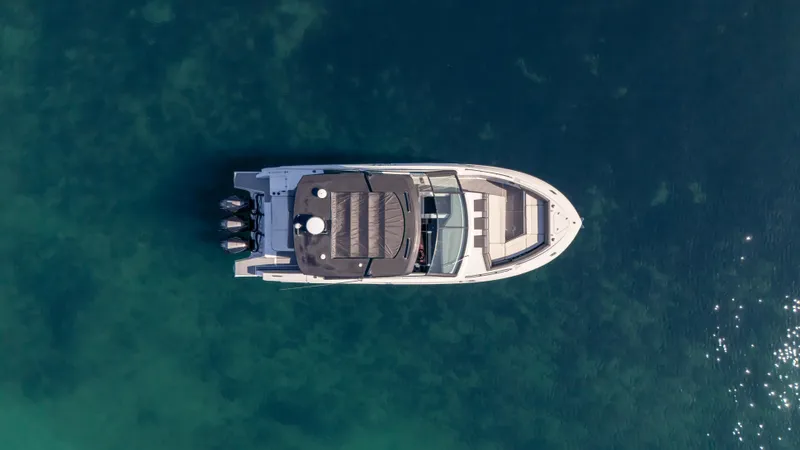  Yacht Photos Pics Aerial view of 2021 Cruisers Yachts 38 GLS OB 450R on clear water.