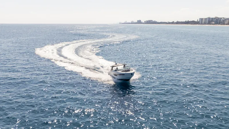  Yacht Photos Pics 2021 Cruisers Yachts 38 GLS OB 450R cruising on open sea, leaving a wake trail.