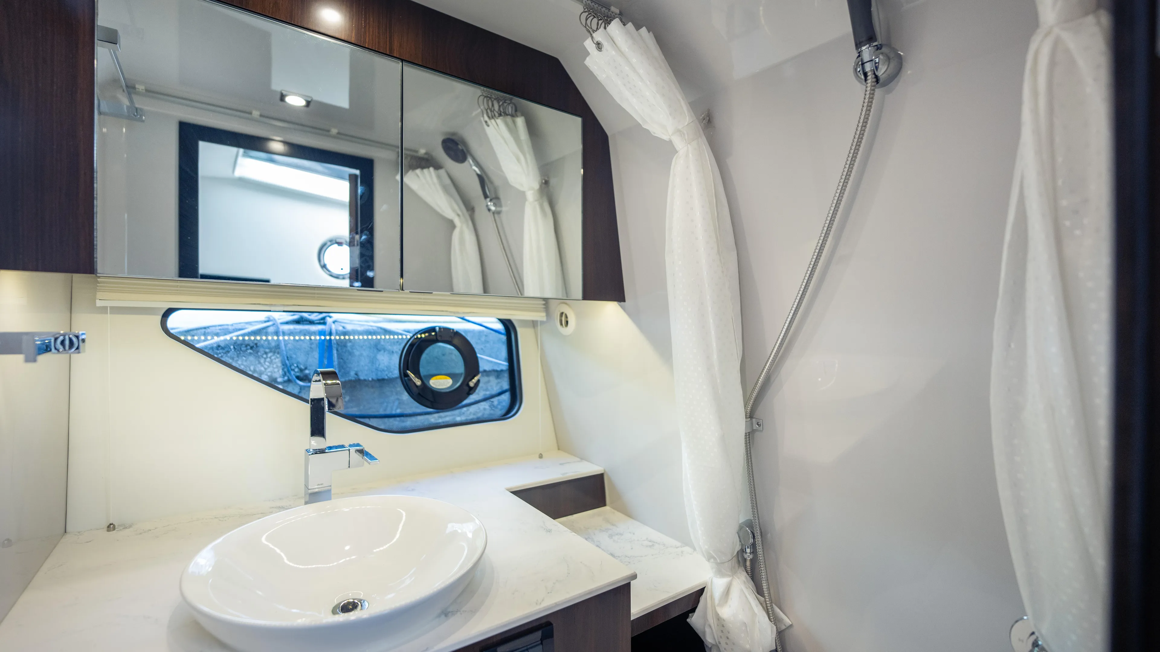  Yacht Photos Pics Modern bathroom in 2021 Cruisers Yachts 38 GLS OB 450R with sleek fixtures and mirror.