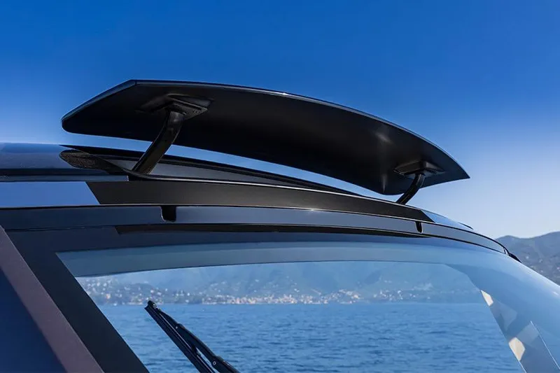  Yacht Photos Pics 2024 Invictus TT460 boat with sleek roof spoiler, ocean backdrop.