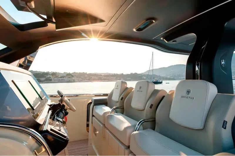  Yacht Photos Pics 2024 Invictus TT460 yacht interior with luxurious seating and scenic ocean view.