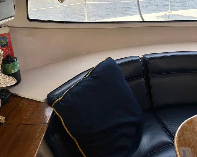 Felice Yacht Photos Pics Interior of 1998 Fountaine Pajot Athena 38 yacht with black leather seating and window view.
